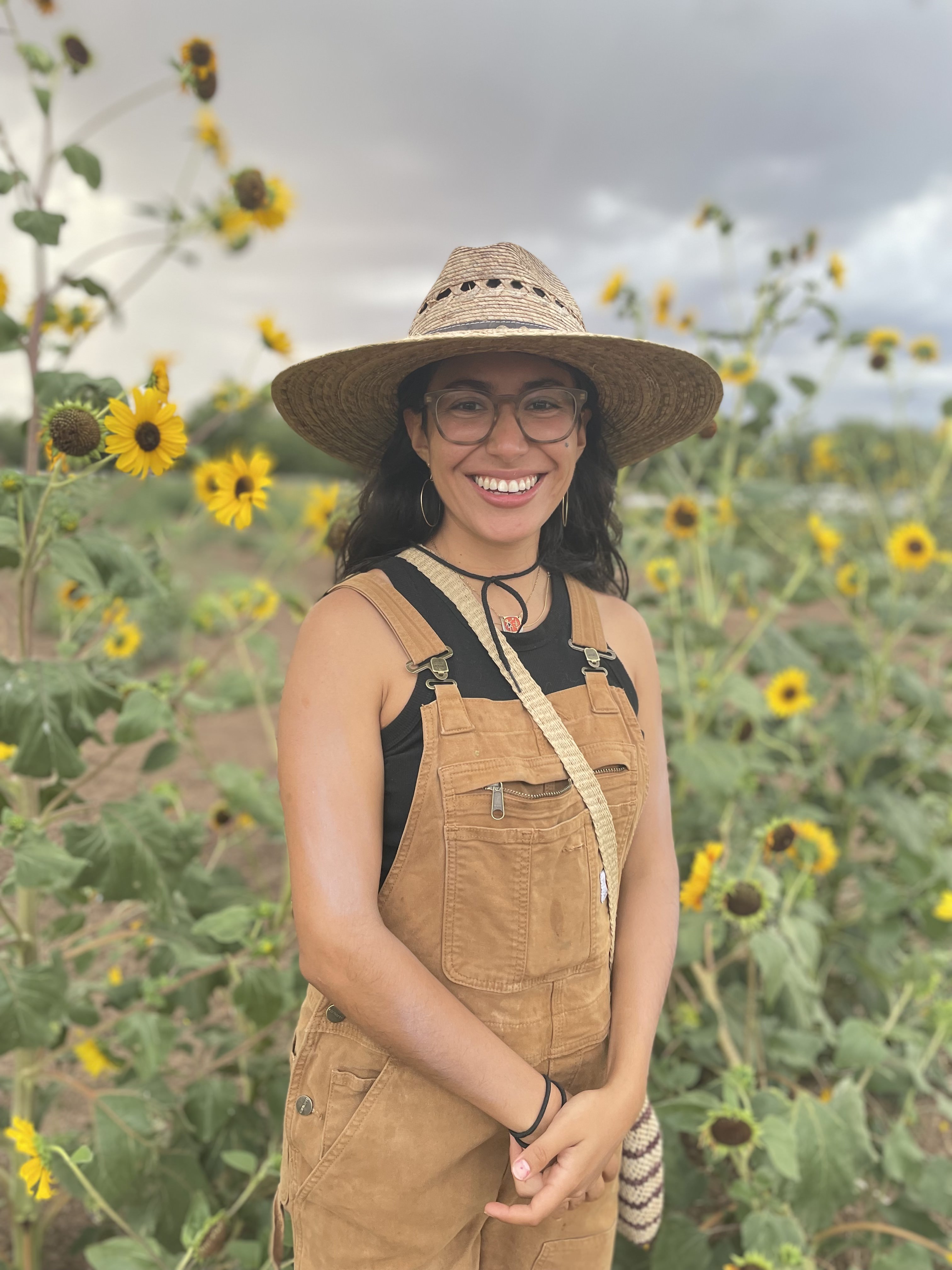 A photo of Esperanza with some sunflowers in the background