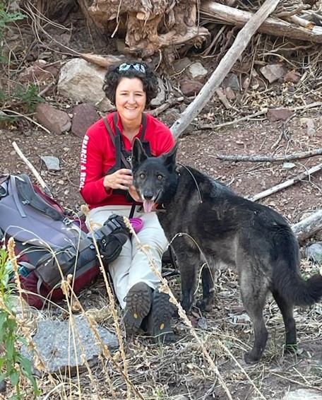 A photo of Dayna in the field with her dog.