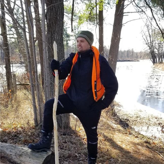 A photo of Hardt standing near a river in winter.